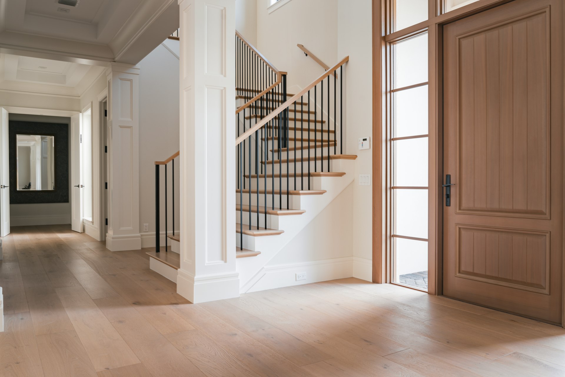 A large room with a staircase and a wooden door